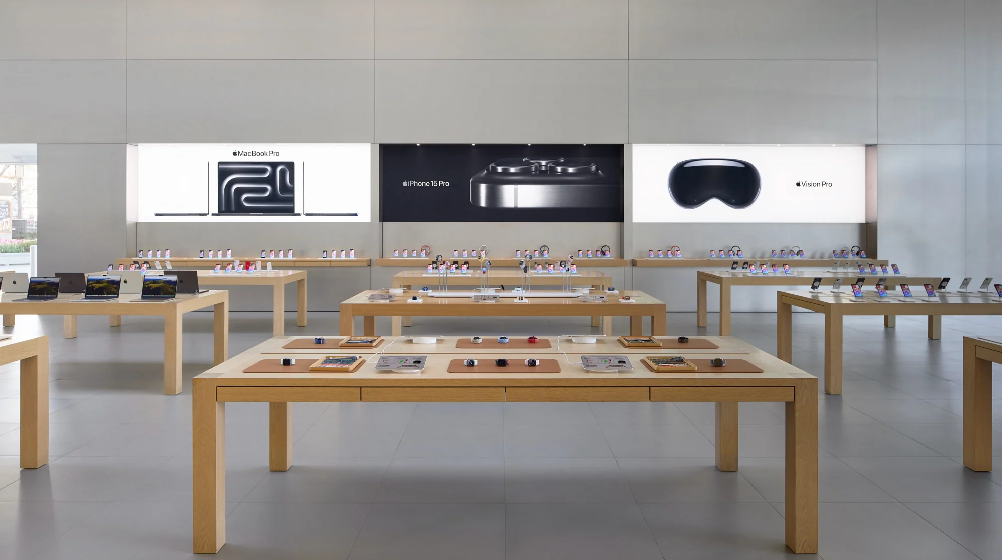 Apple Lincoln Park retail displays with MacBook Pro, iPhone 15 Pro and Vision Pro campaign signage