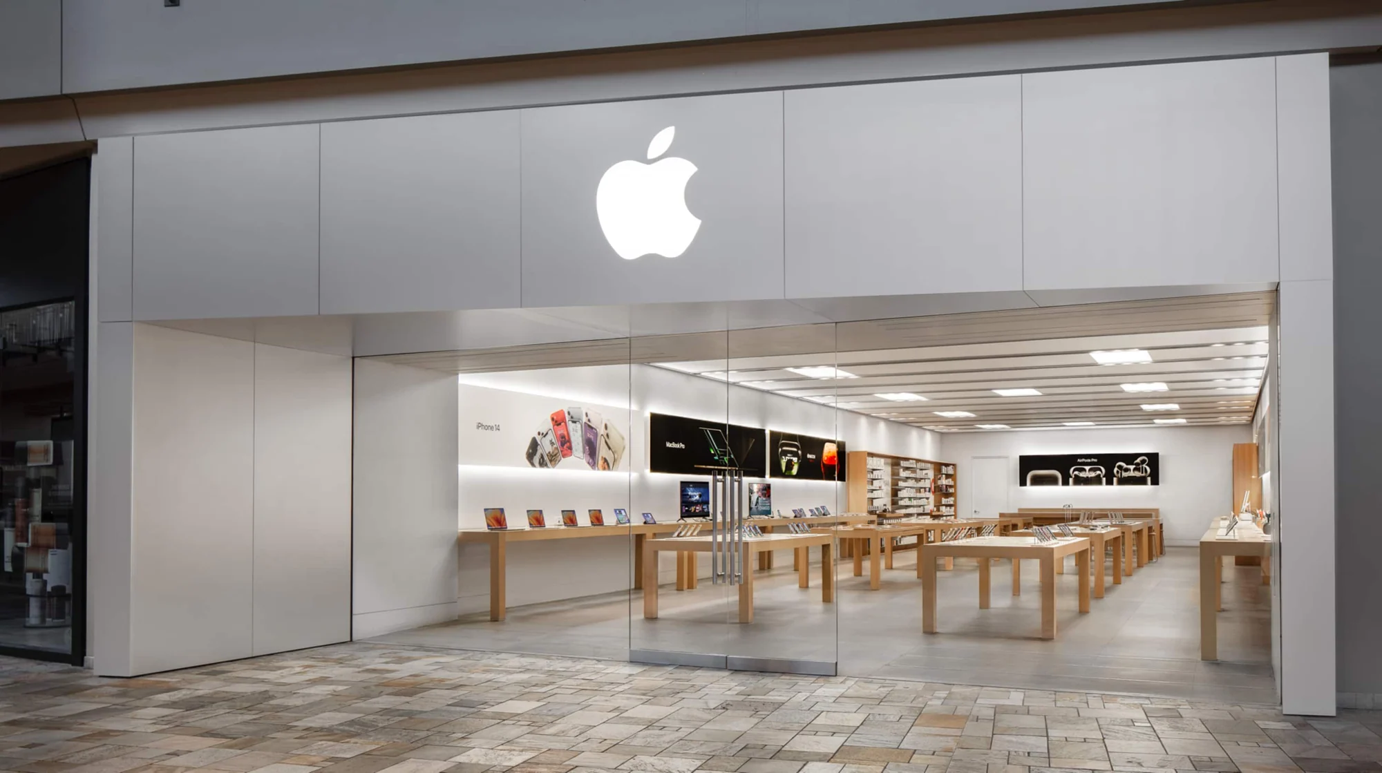 Apple storefront with illuminated logo and product launch signage