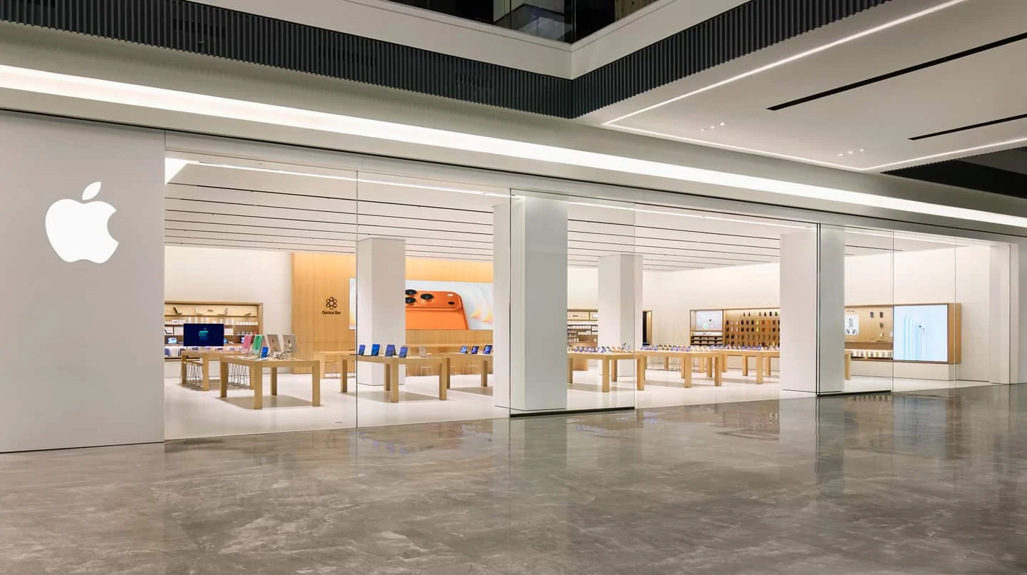 Apple retail signage and product displays across a storefront